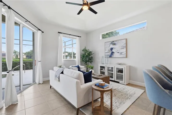 Living space featuring large sliding glass doors, a transom window, and tiled flooring