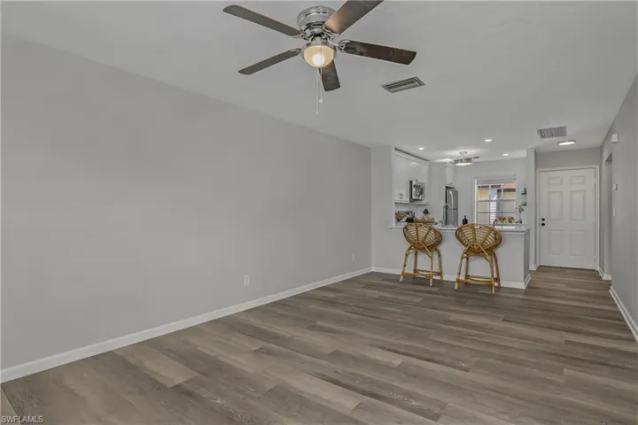 Additional Living Room Views with ample entertainment space.  Enjoy the new vinyl flooring, trim, ceiling fans and outlets.