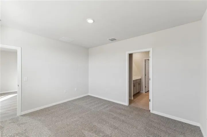 Unfurnished room featuring light carpet