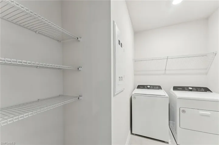 Laundry room featuring washer and clothes dryer