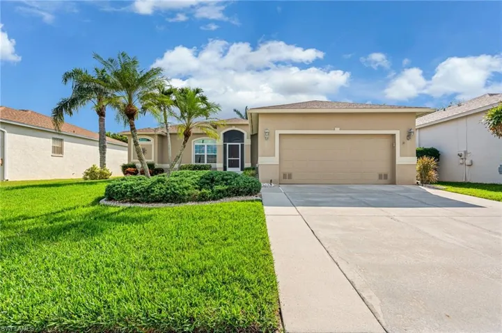 View of front of house with a front lawn and a garage