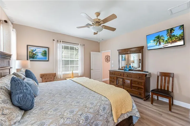 Bedroom featuring ceiling fan and wood-type flooring