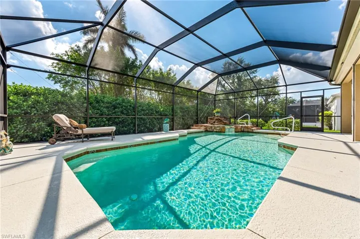 View of pool with a lanai and a patio