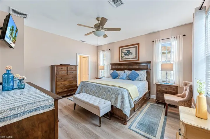 Bedroom with light hardwood / wood-style floors and ceiling fan