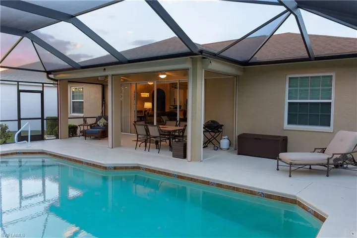 View of pool with a patio and a lanai
