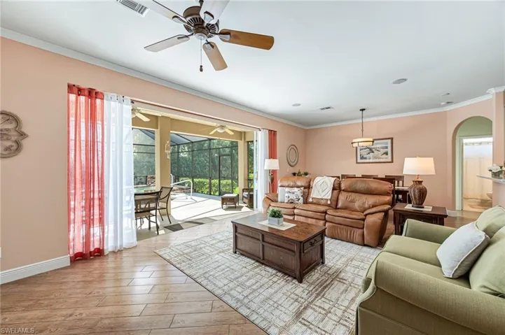 Living room featuring crown molding and light wood-type flooring