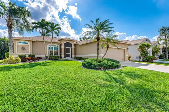 View of front of house with a front yard and a garage