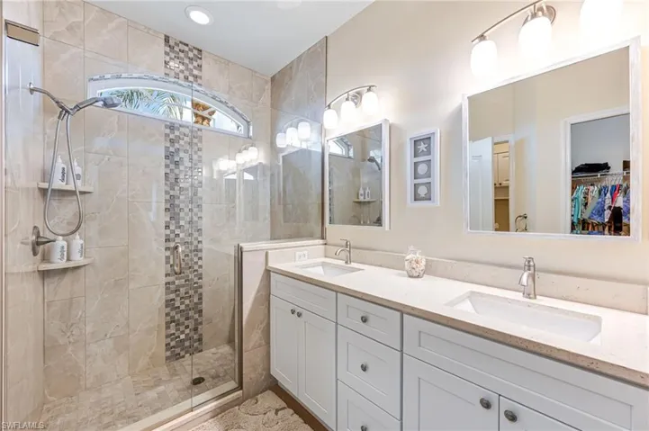 Bathroom featuring vanity and a shower with shower door