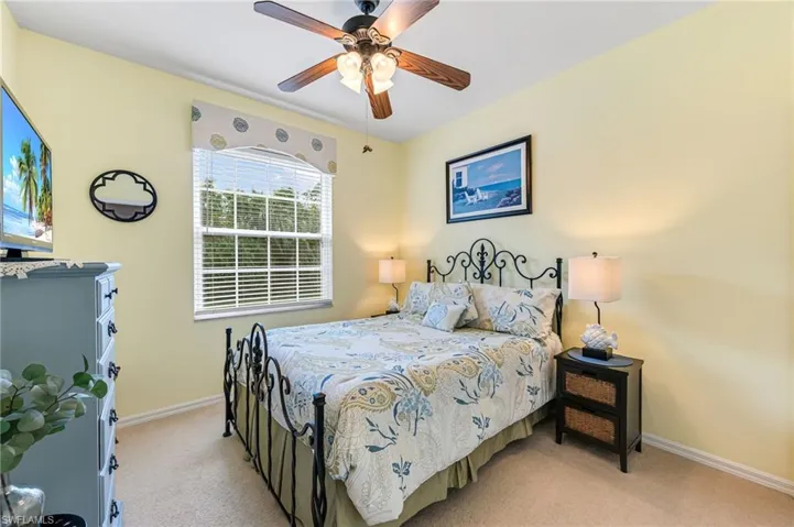 Bedroom featuring ceiling fan and light colored carpet