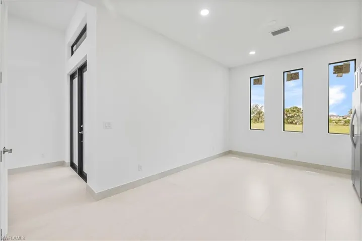 Spare room featuring recessed lighting and baseboards