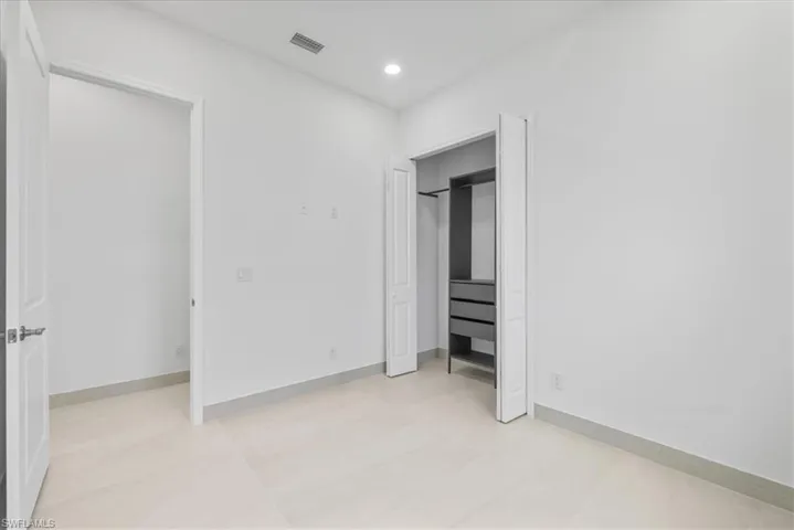 Unfurnished bedroom with recessed lighting and baseboards