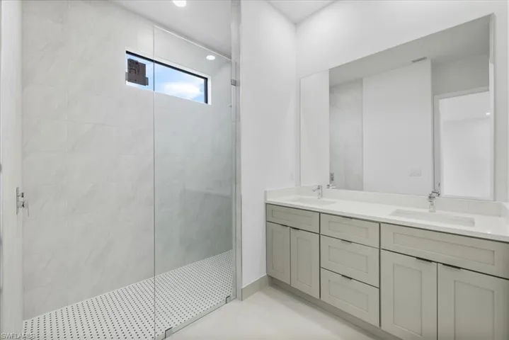 Master Bathroom featuring double vanity and walk in shower
