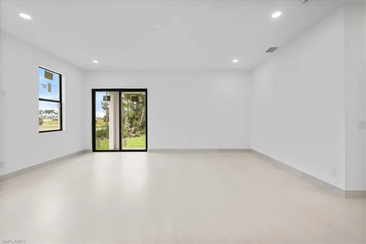 Spare room featuring recessed lighting and baseboards