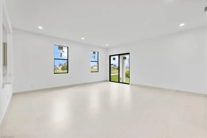 Spare room with recessed lighting and baseboards