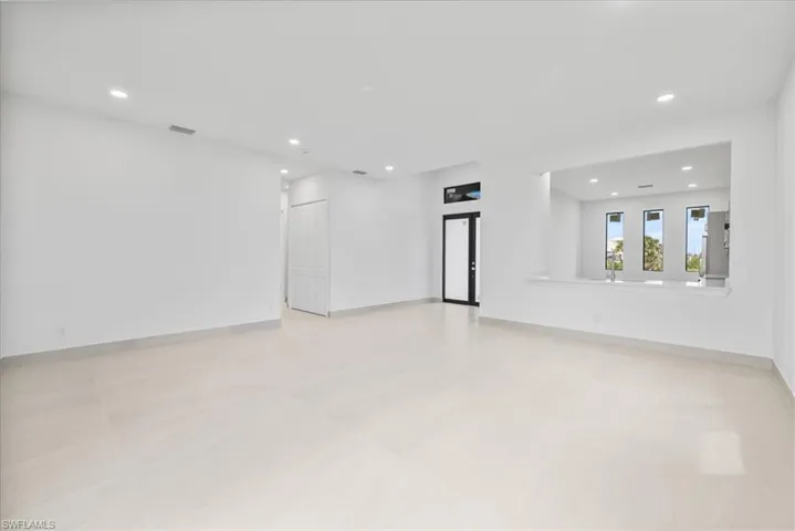 Unfurnished room with recessed lighting and baseboards