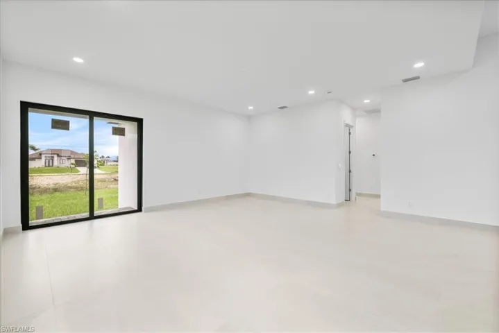 Unfurnished room with recessed lighting and baseboards