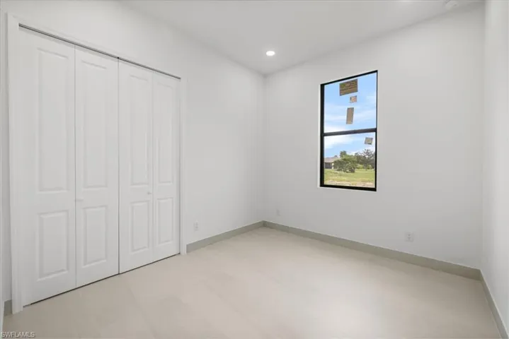 Unfurnished bedroom with recessed lighting and a closet
