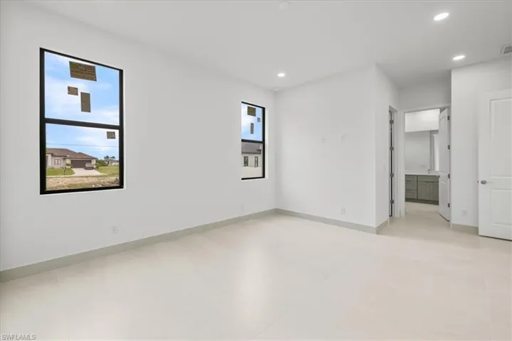 Unfurnished Master bedroom with recessed lighting and ensuite bathroom