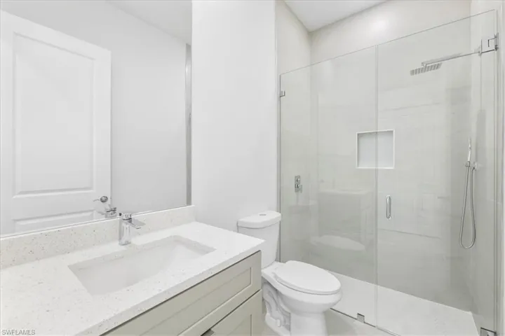 Full bathroom featuring vanity and a stall shower