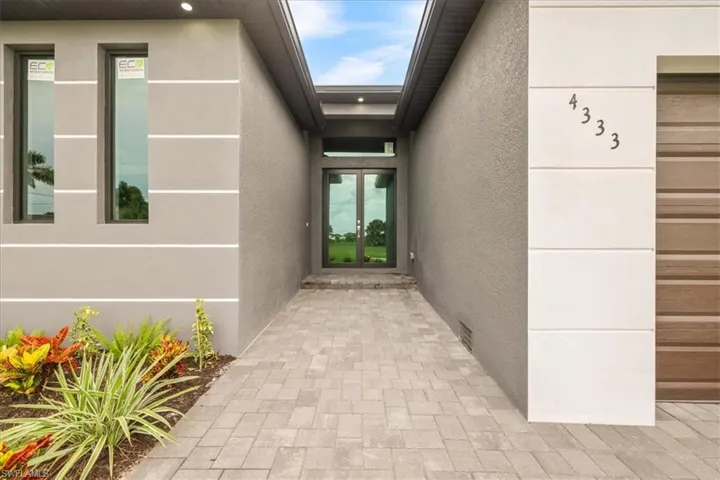 Doorway to property with stucco siding and french doors