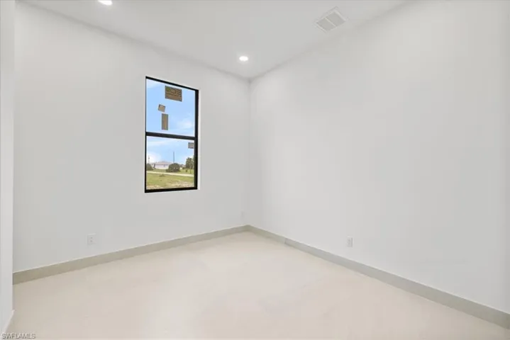 Unfurnished room featuring recessed lighting and baseboards
