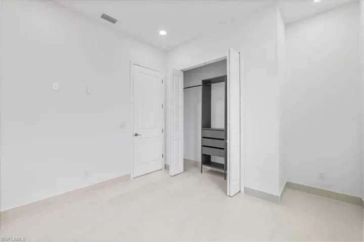 Unfurnished bedroom featuring recessed lighting and a closet