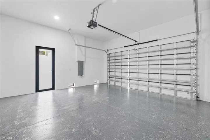 Garage with electric panel and a garage door opener
