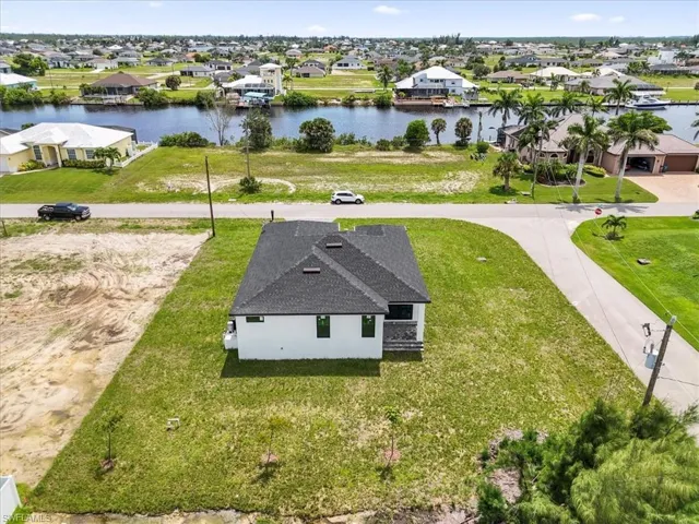 Aerial perspective of suburban area featuring a large body of water