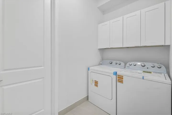 Laundry room featuring washing machine and dryer and cabinet space