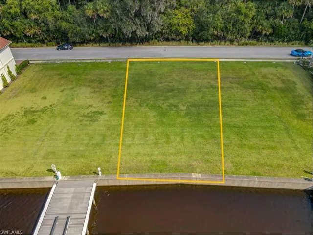 Aerial view of property and surrounding area with property parcel outlined