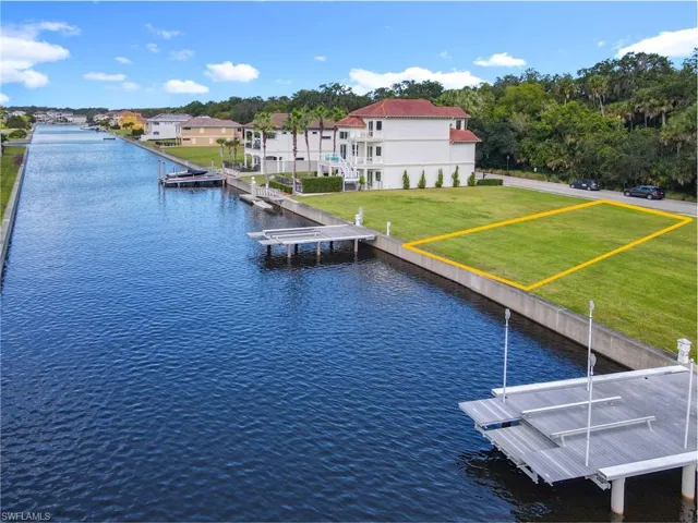 Dock featuring a lawn and a water view