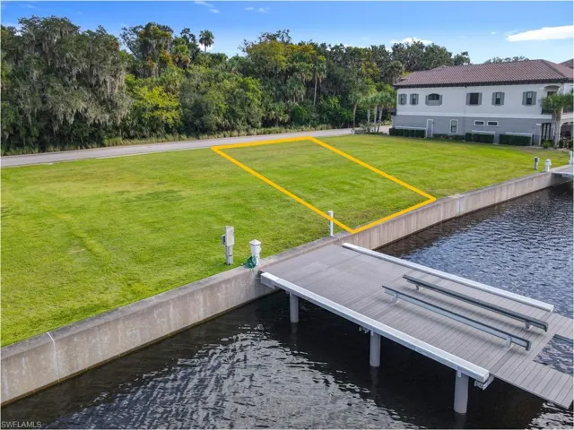 Dock featuring a lawn and a water view