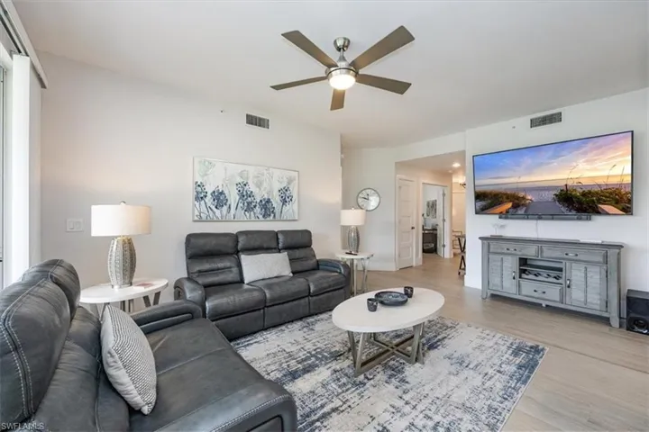 Living area with wood finished floors and a ceiling fan