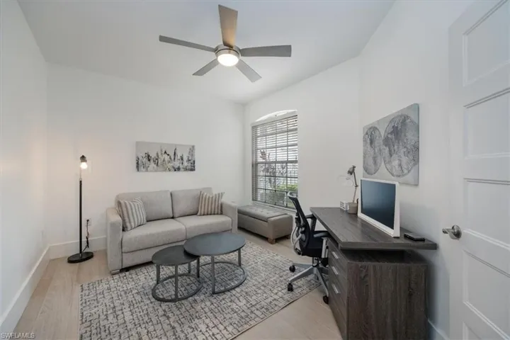 Home office with light wood finished floors and ceiling fan