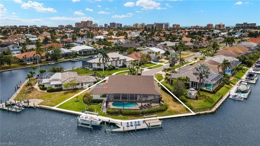 Aerial view of residential area featuring a large body of water and skyline