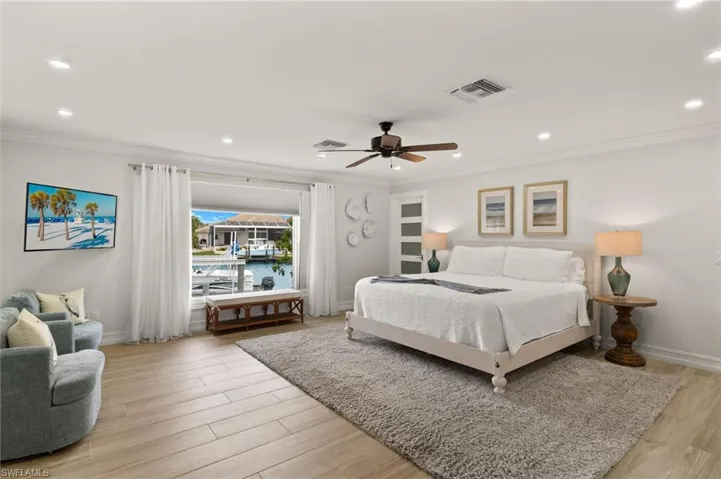 Bedroom with recessed lighting, light wood-type flooring, ceiling fan, and crown molding