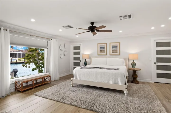 Bedroom with light wood-style flooring, recessed lighting, ornamental molding, and a ceiling fan