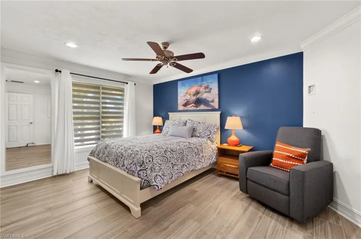 Bedroom featuring ornamental molding, light wood-style flooring, ceiling fan, and recessed lighting