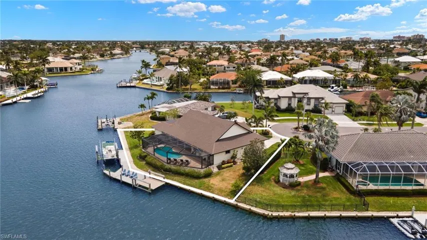 Aerial view of residential area featuring a nearby body of water