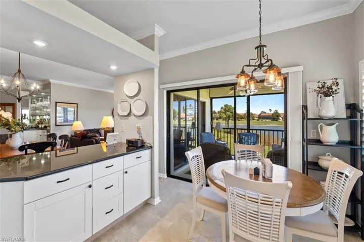 Kitchen dining area featuring a sliding glass door to a balcony with water views