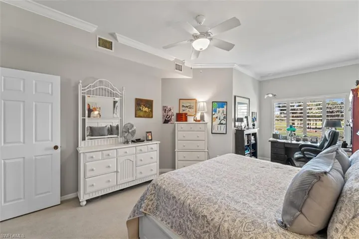 Carpeted interior space featuring white crown molding and a ceiling fan with integrated lighting