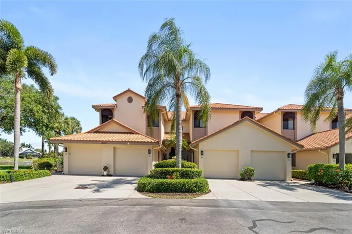 Mediterranean-style architecture featuring a tile roof and stucco exterior