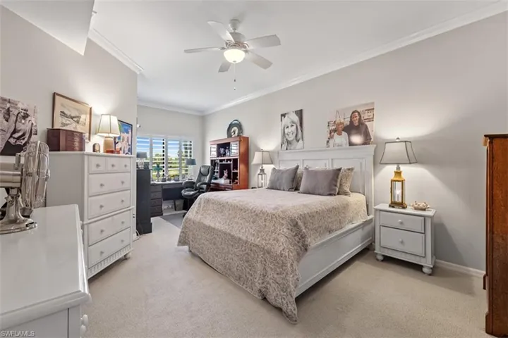 Spacious room featuring light-colored walls, crown molding, and carpeted flooring