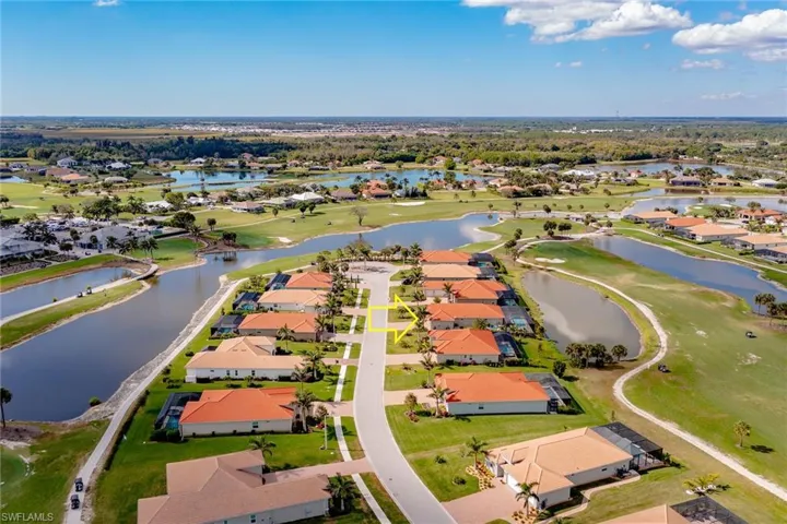 Bird's eye view with golf course view, a water view, and a residential view