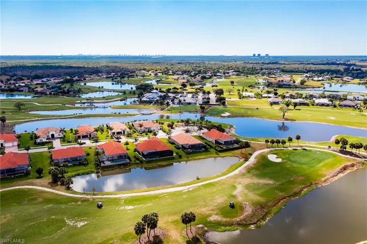 Birds eye view of property featuring golf course view, a water view, and a residential view