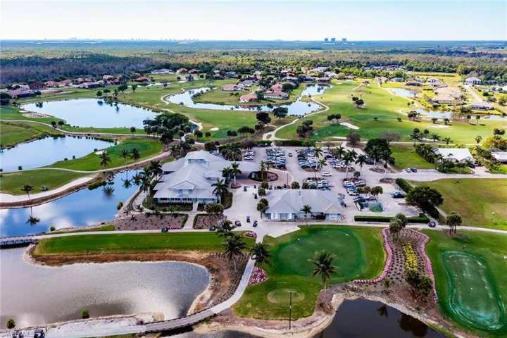 Aerial view featuring a water view and golf course view