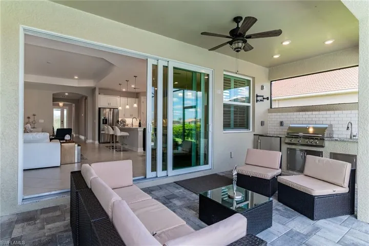 View of patio / terrace with outdoor lounge area, an outdoor kitchen, a sink, and area for grilling