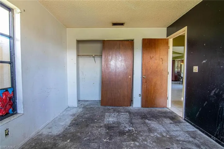 Unfurnished bedroom with tile patterned floors and a textured ceiling