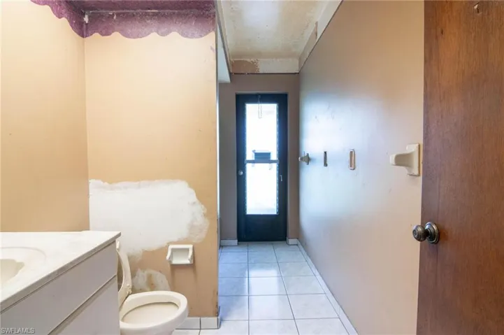 Bathroom with vanity, tile patterned floors, and toilet