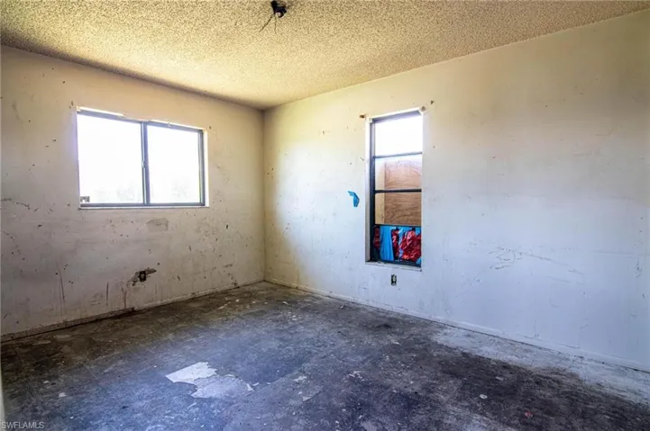 Empty room featuring a textured ceiling